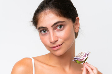 Fototapeta premium Young Pretty caucasian woman isolated on white background holding flowers. Close up portrait