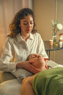 Professional massage therapist giving shoulder massage in a spa salon