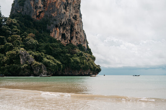 Limestone cliff rising above Railay West Beach and Andaman Sea