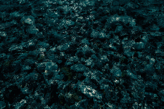Dark pebble refraction with copy space 