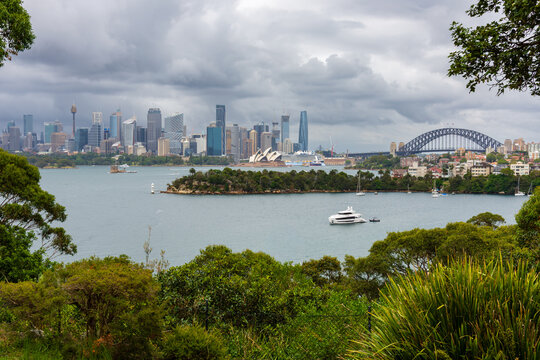 Sydney City, Opera House and Harbour Bridge on a cloudy day as seen from Mosman