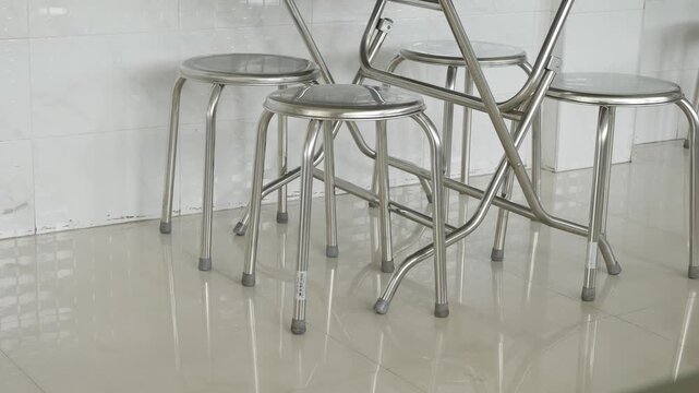 stainless steel round stools and folding tables in a clean modern Asian restaurant