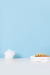 Pastel blue wall bathroom with bamboo brush and white towel