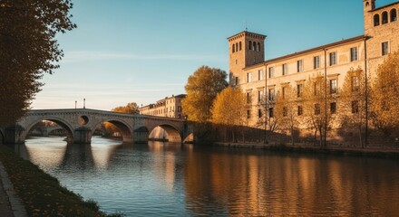 Obraz premium River flowing through a historic european city with ancient buildings and a bridge