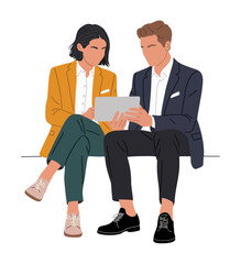 Fototapeta premium Two people sit closely, sharing a tablet together. One wears a bright yellow blazer, the other a navy suit. They focus on the screen, suggesting teamwork or collaboration. Their posture shows comfort