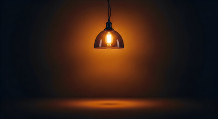 Obraz premium Warm glowing pendant light hanging from ceiling in dark room with soft orange illumination on walls and floor