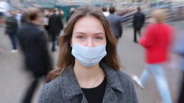 Protected in the Crowd: A woman wearing a surgical mask navigates a bustling urban environment, symbolizing the ongoing need for vigilance amidst a sea of individuals.