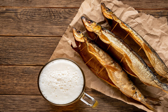 Hot smoked fish Baikal omul Coregonus autumnalis on wooden table