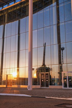Reflection of Buran space shuttle model in a glass facade of Science University. Sirius. Russia
