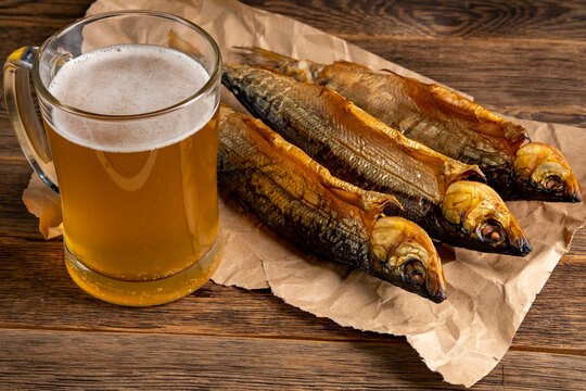 Hot smoked fish Baikal omul Coregonus autumnalis on wooden table