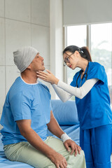 A male cancer patient on bed receives IV therapy while a female doctor offers care encouragement and updates on his test results providing support and discussing health progress