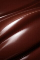 Fototapeta premium Smooth waves of rich dark chocolate creating an appetizing and delicious abstract texture with subtle reflections, perfect for food and indulgence concepts