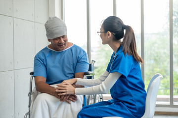 Obraz premium A male cancer patient in a wheelchair receives IV therapy while a female doctor offers care encouragement and updates on his test results providing support and discussing health progress