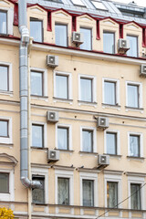 Fototapeta premium Air conditioner condenser. There are air conditioners installed on the wall of house. air cooling technologies in hot weather. air temperature, climate control. fans in home and office.