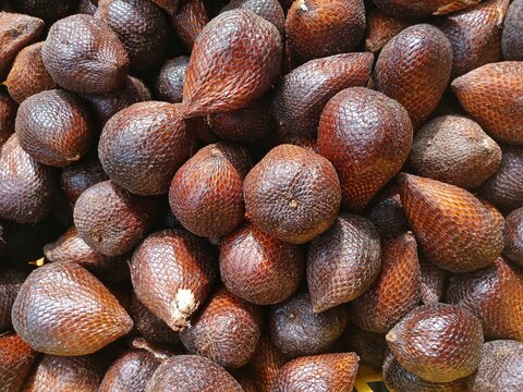 Pile of Salak fruit (Salacca zalacca) in the supermarket, a fruit with a distinctive sweet taste and slightly astringent but crunchy.