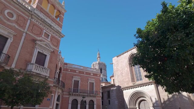 Cathedral and historic buildings of the city of Valencia on a sunny day with blue skies, Spain.