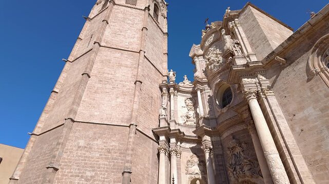 Main facade of the Gothic cathedral of Valencia with its famous Miguelete, Spain tower.