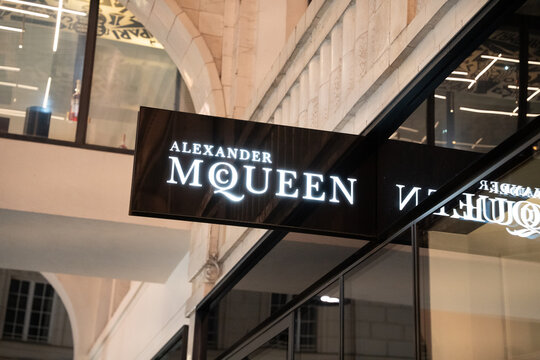 Vienna, Austria- Feb 21, 2026: Illuminated Alexander McQueen storefront showcasing fashion luxury. Modern design highlights elegance and style in a vibrant shopping district.