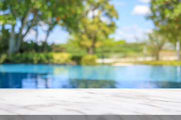 Fototapeta premium Empty marble table top with blur outdoor swimming pool in tropical resort hotel summer background
