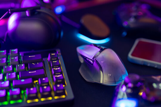 A collection of gaming essentials: Various controllers and portable gaming devices neatly arranged on a light gray background. Stock photo highlighting contemporary gaming hardware and modern play