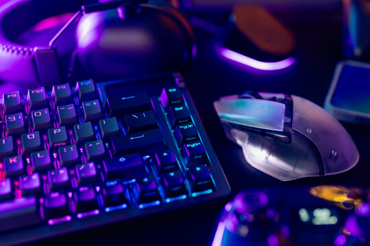A collection of gaming essentials: Various controllers and portable gaming devices neatly arranged on a light gray background. Stock photo highlighting contemporary gaming hardware and modern play