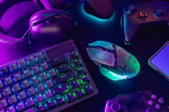 A collection of gaming essentials: Various controllers and portable gaming devices neatly arranged on a light gray background. Stock photo highlighting contemporary gaming hardware and modern play