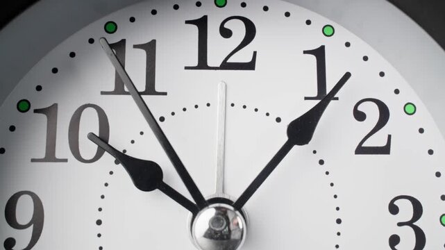 Vintage alarm clock. Old fashioned alarm clock with bells. Time moving. Time concept. Table clock show running time. Close-up in 4K, UHD