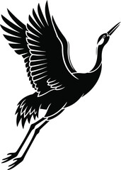 Fototapeta premium Silhouette of a flying crane in mid air