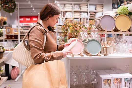 Woman Choosing Plates In A Home Decor Store