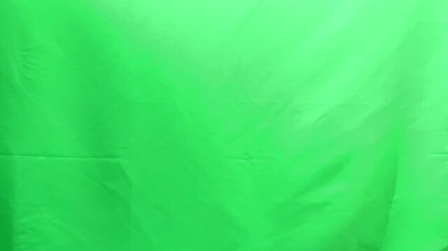 Female hand showing middle finger gesture against green chroma background. Woman expressing rude sign through extended finger symbol. Negative communication concept representing insult protest or.