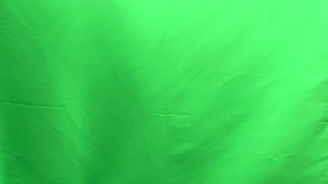 Index finger pressing virtual button gesture on green chroma background. Human hand performing click interaction for digital interface control. Touch screen navigation concept for user command.