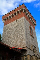 Medieval stone and brick tower against blue sky, Krakow, Poland © Rudolf Tepfenhart