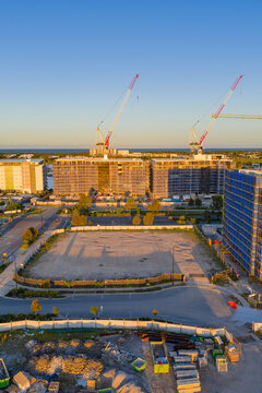 Aerial view of  tall cranes on a construction site on top of highrise buildings