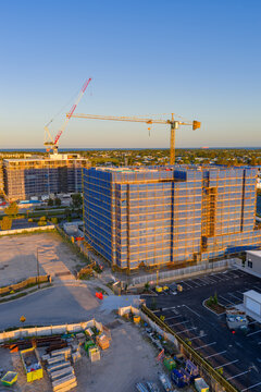 Aerial view of  tall cranes on a construction site on top of highrise buildings