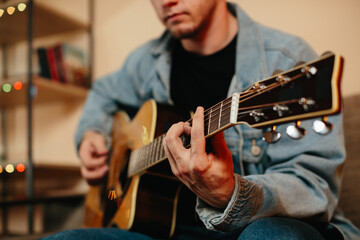 Obraz premium Musician composing music playing acoustic guitar at home