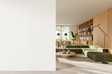 Modern interior wall mockup in bright living room with green sofa, wooden shelving, and clean...