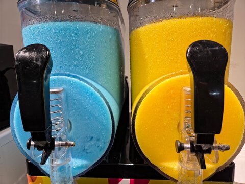 Blue and Yellow Frozen Slushie Beverage Dispensers in a Dual Tank Machine