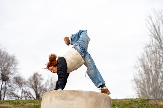Young woman practicing parkour in urban environment