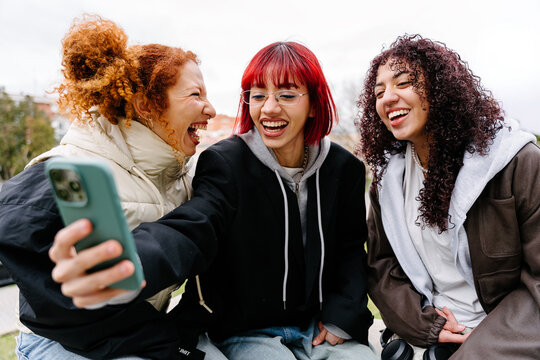 Friends taking a joyful selfie in urban setting