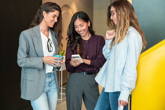 Young businesswomen engaged in empowering teamwork