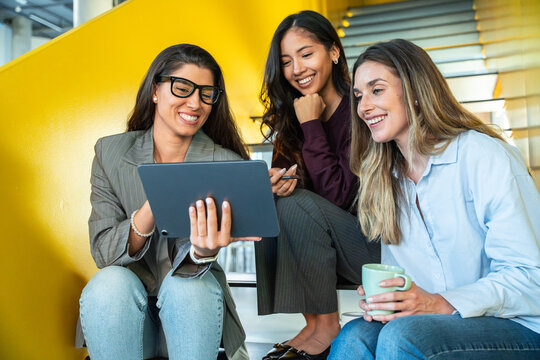 Empowered businesswomen collaborating with technology