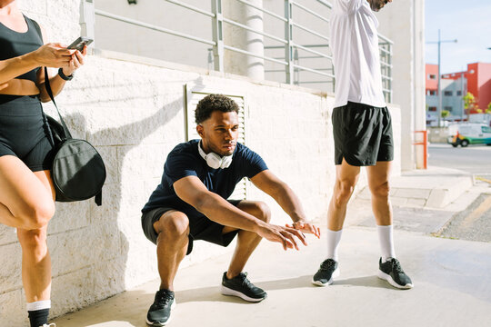 Outdoor fitness group exercising together in sunlight
