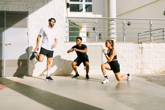 Multiethnic friends exercising outdoors in city setting
