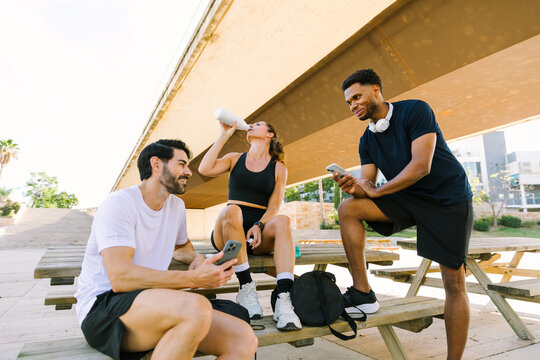 Multiethnic group of friends takes a break from urban sports