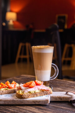 Gourmet breakfast with latte and charcuterie board
