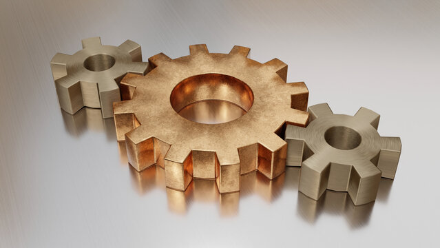 Metal gears arranged on reflective industrial steel surface