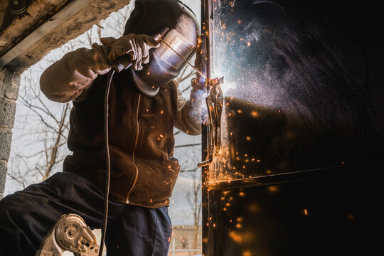 Professional welder working in protective gear