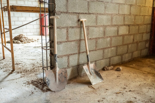 Construction tools at brick wall building site