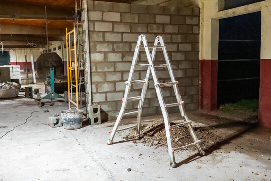 Empty construction site with ladder and tools