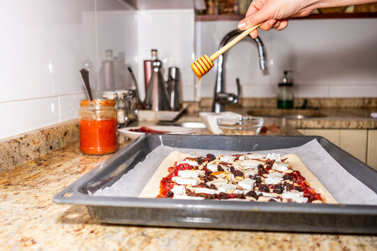 Preparing a fresh fruit pie with honey drizzle
